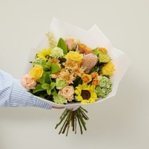 Bright citrus-inspired flower bouquet with yellow roses, carnations and lush foliage – Bloomin Boxes Perth